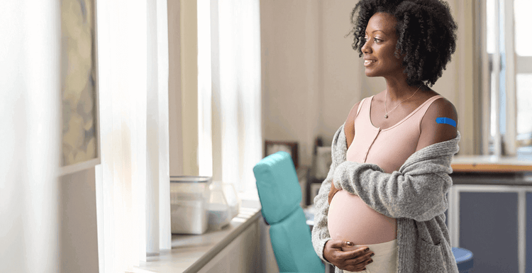 Actor portrayal of a pregnant woman feeling her belly