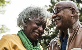 Actor portrayal of a woman and a man laughing together