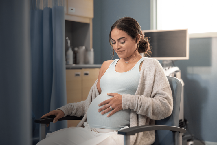 Pregnant woman with a breath counter with language that states that you'll take about six million breaths as you prepare to meet your baby